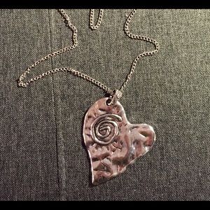 Large heart shaped necklace with long chain.